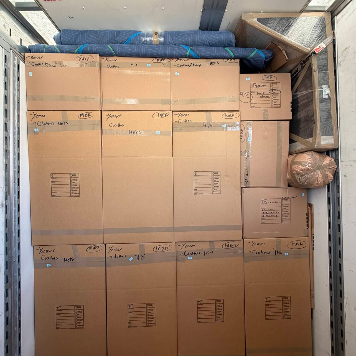 Labeled clothing boxes stacked in truck